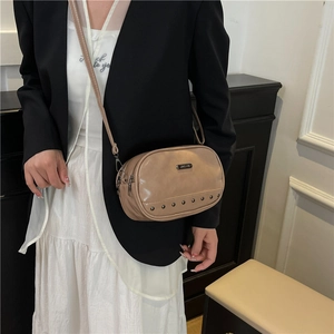 Minimalist khaki leather crossbody camera bag with metal rivets and double zippers