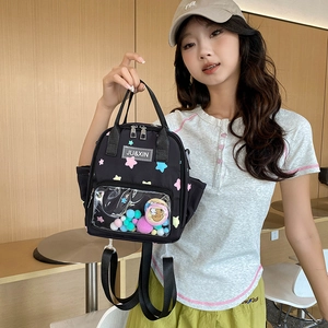 Schwarzer Nylon-Rucksack mit bunten Sternen und einer transparenten PVC-Fronttasche