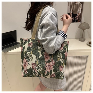 Detail of floral jacquard tote bag featuring vintage green leaves and pink flower patterns