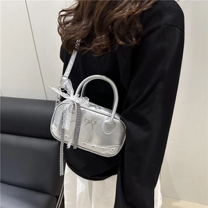 Silver metallic handbag with lace bow decor and heart embossing for women