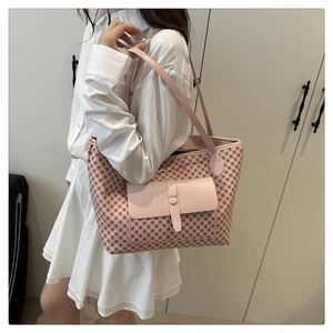 Detailed shot of pink polka dot tote bag with front flap pocket on a model