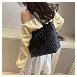 Close-up of a large black tote bag with light blue geometric pattern and card pocket