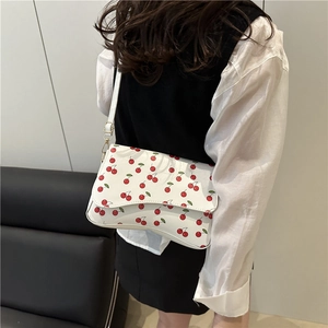 Fresh white cherry print crossbody shoulder bag shown on model for 2025 summer trend