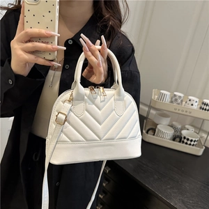 Elegant white quilted shell bag with V-pattern and gold hardware for women's crossbody use