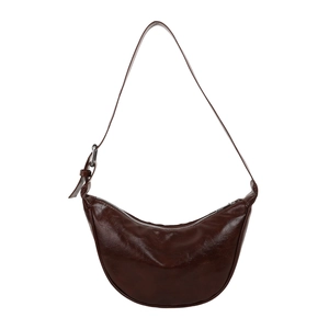 Brown leather crescent hobo bag with adjustable strap and polished finish on white background