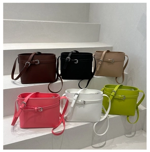 Detailed collection of minimalist leather bucket bags in six colors on white steps