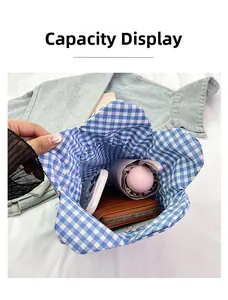 Internal storage view of the blue plaid crossbody bag holding a phone and umbrella