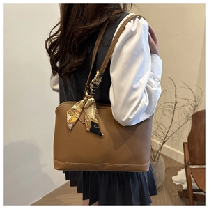 Brown leather tote bag with vintage silk scarf detail shown on model for daily commute