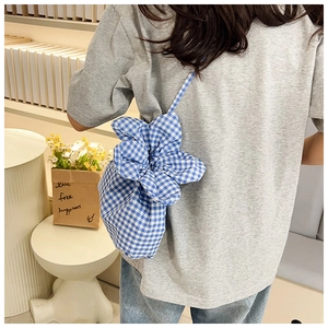 Detailed back view of a blue gingham floral bucket bag with petal-shaped design and slim strap