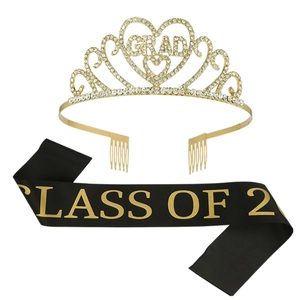Close-up of golden GRAD rhinestone crown and black CLASS OF 2 satin sash set