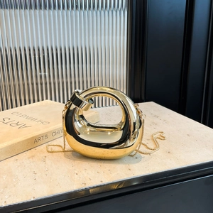 Modern gold acrylic mini handbag with a twisted ring design and elegant metal chain strap
