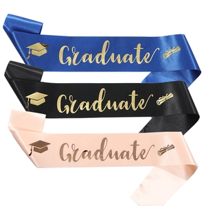 Three satin graduation stoles in blue, black, and pink with golden Graduate lettering