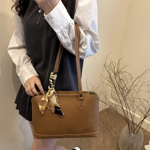 Brown leather tote bag with decorative silk scarf for summer daily commuting use