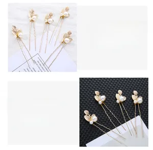 Detailed close-up of golden leaf hair pins with white pearls for elegant bridal hairstyles