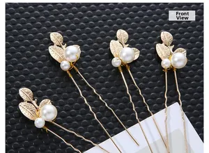 Detail view of pearl leaf hair pins featuring golden metal leaves and elegant white pearls