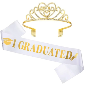 Detail of gold rhinestone graduation crown and white satin I GRADUATED sash set