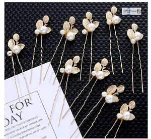 Detail of 10pcs gold leaf hair pins with elegant white pearls for bridal hairstyles