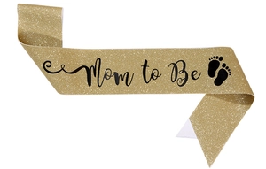 Detail of Mom to Be sash with gold glitter texture and black lettering for baby showers