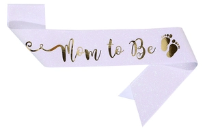 Detail of purple glitter Mom to Be sash with gold foil text and baby footprint patterns