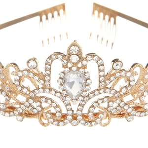 Close-up of golden crystal crown featuring a large teardrop stone and intricate filigree