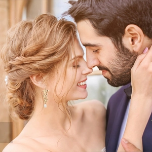 Dettaglio orecchini a foglia d'orchidea dorata con pendente di perla da sposa