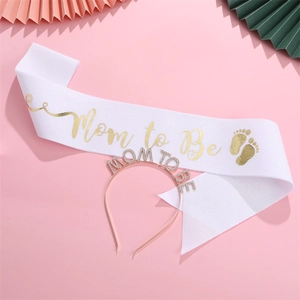 Close-up of Mom to Be glitter sash and rhinestone crown set for baby shower party