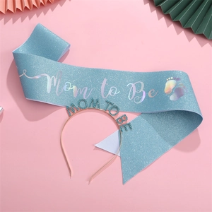 Macro view of blue Mom to Be sash with laser lettering and sparkling rhinestone headband