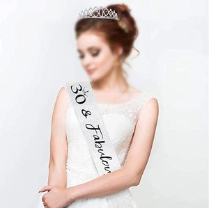 Close-up of silver glitter sash with '30 & Fabulous' text and a rhinestone number crown