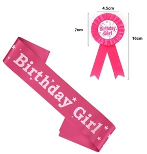 Detail of pink Birthday Girl sash and matching rosette badge for party celebration
