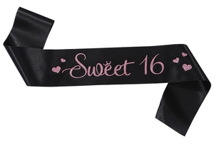 Close-up of black satin sash with pink glitter Sweet 16 lettering and crown design