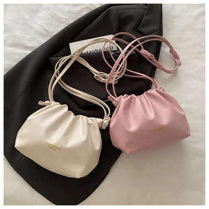 Detail of off-white and pink pleated bucket bags with drawstring and fashion logo