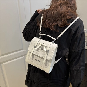 Chic beige backpack with delicate lace embroidery and heart charm for modern women