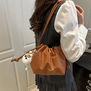 Brown pleated large capacity PU leather bucket bag with a white pompom for women