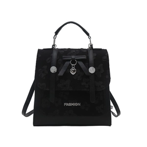 Minimalist black backpack for women with floral texture, bow detail and heart pendant