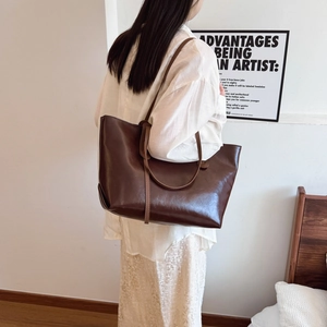 Large dark brown faux leather tote bag for women, ideal for commuting and daily use