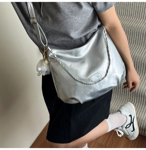 Silver hobo shoulder bag with metallic finish and cute white lamb plush charm