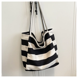 Detail of the high-quality thick canvas texture on a black and white striped tote bag