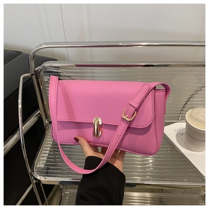 Detail of Barbie pink crossbody bag with a gold metal clasp and adjustable strap