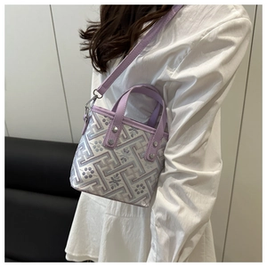 Detail of lilac and white geometric tote bag with floral pattern shown on a model