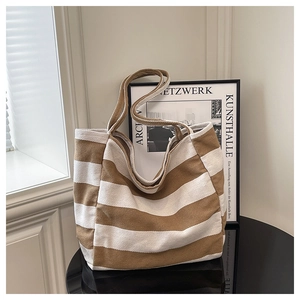 Detail of striped canvas tote bag showing thick fabric texture and spacious interior