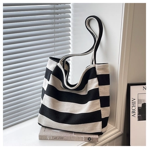 Close-up of a striped canvas tote bag texture with natural sunlight and aesthetic decor