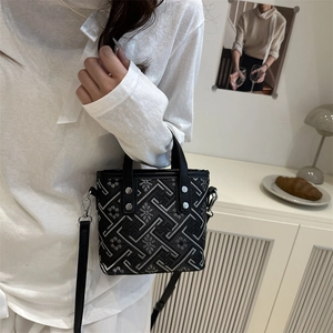 Large capacity geometric patterned bucket bag with leather handles and crossbody strap