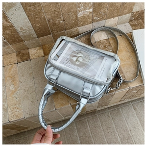 Silver square ita bag with clear display window and double zipper in top-down view