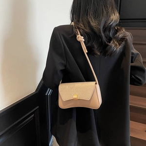 Stylish beige glitter shoulder bag with gold clasp and knot detail for elegant women