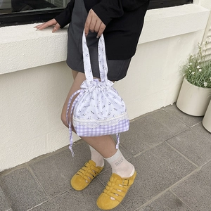 Floral and checkered drawstring bucket bag with lace trim in purple and white color