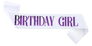 Close-up of white satin birthday girl sash with purple metallic foil lettering