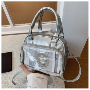 Detail of silver ita bag with transparent PVC window and adjustable crossbody strap