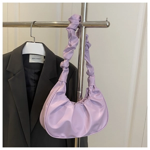 Detail of light purple pleated cloud bag showing synthetic leather texture and gather design