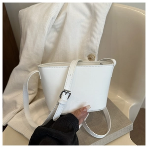 Detail of white leather bucket bag showing embossed Fanvissa logo and silver buckle strap