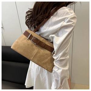 Brown faux suede tote bag detail with leather belt and silver buckle on model shoulder